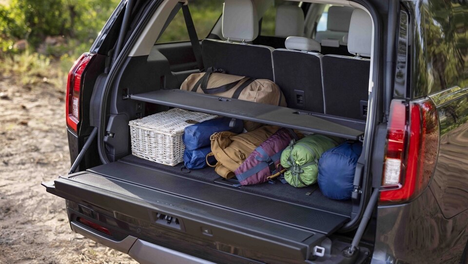 Items loaded in the rear cargo area of a 2025 Ford Expedition® SUV with available Ford Split Gate Cargo Tailgate Manager