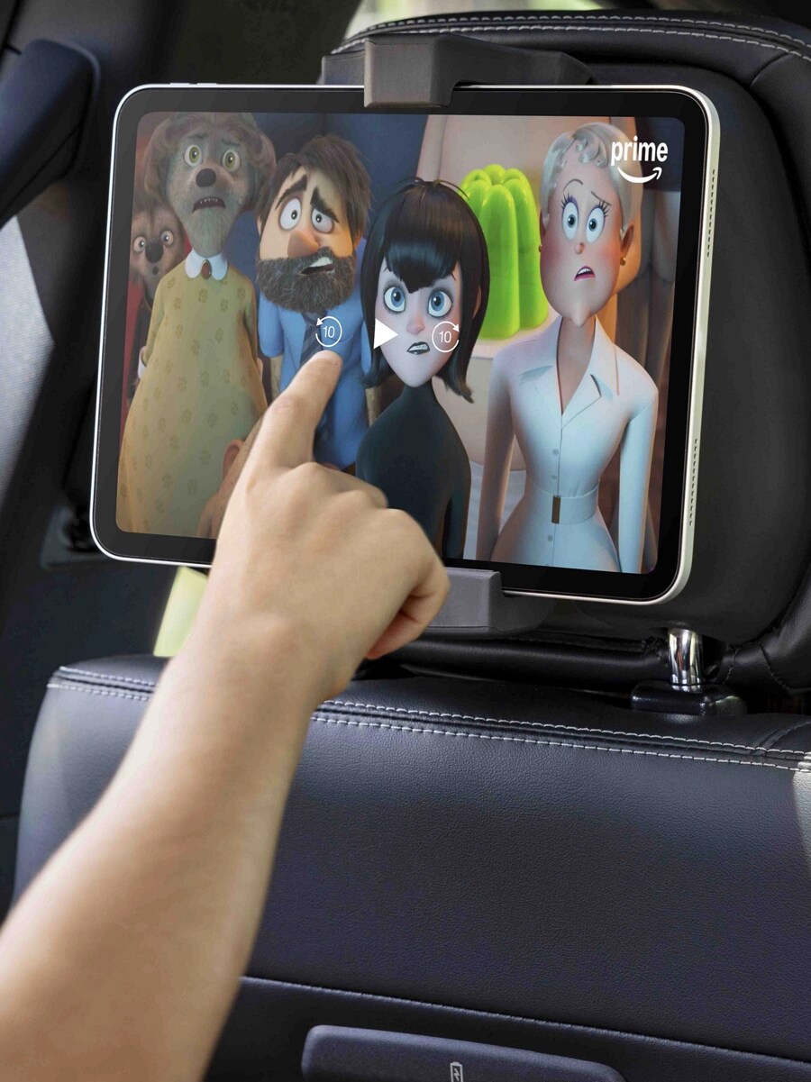 Passenger using a tablet in the available second-row digital device holder in a 2025 Ford Expedition® SUV