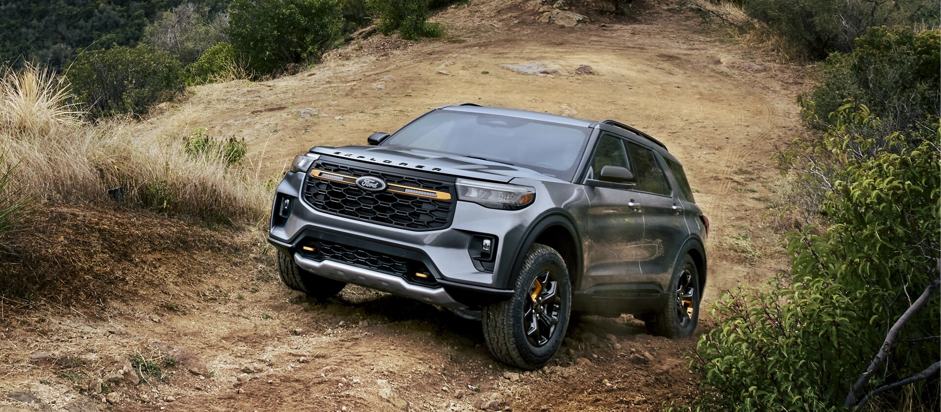 A 2026 Ford Explorer® Tremor® SUV being driven on a dusty mountain road