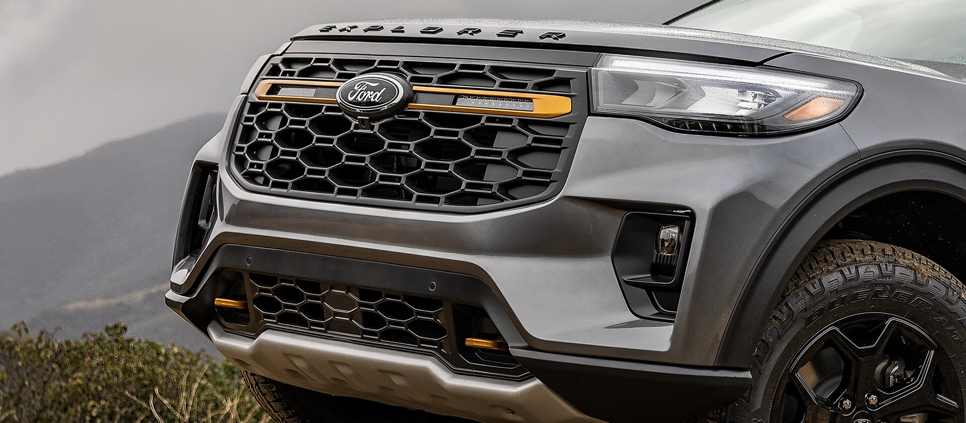 The front grille of a 2026 Ford Explorer® Tremor® SUV, showing the off-road auxiliary lights