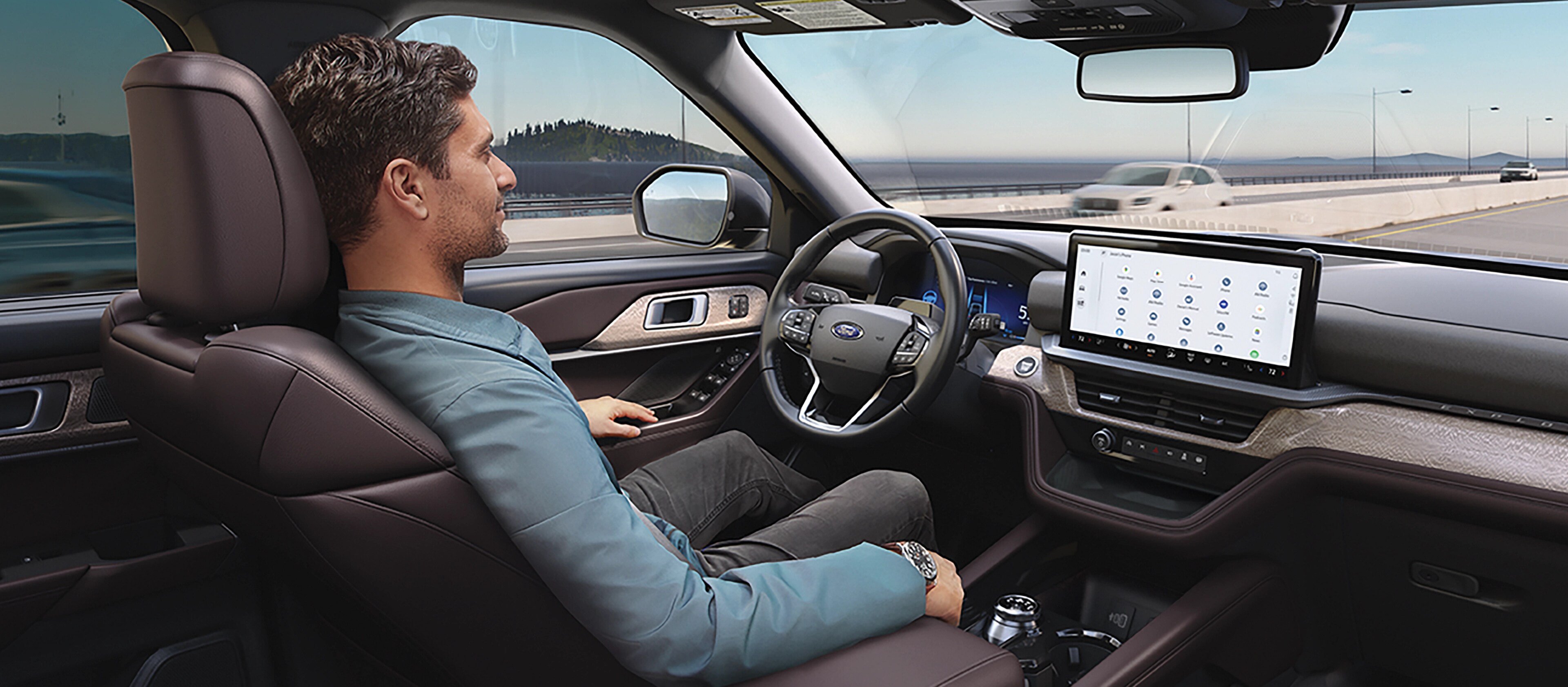 A person in a 2026 Ford Explorer® SUV driving down the highway, using the BlueCruise feature