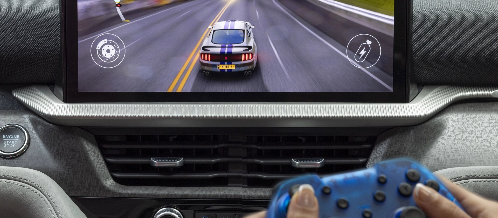A passenger playing a racing game on the centre display of a parked 2026 Ford Explorer® SUV