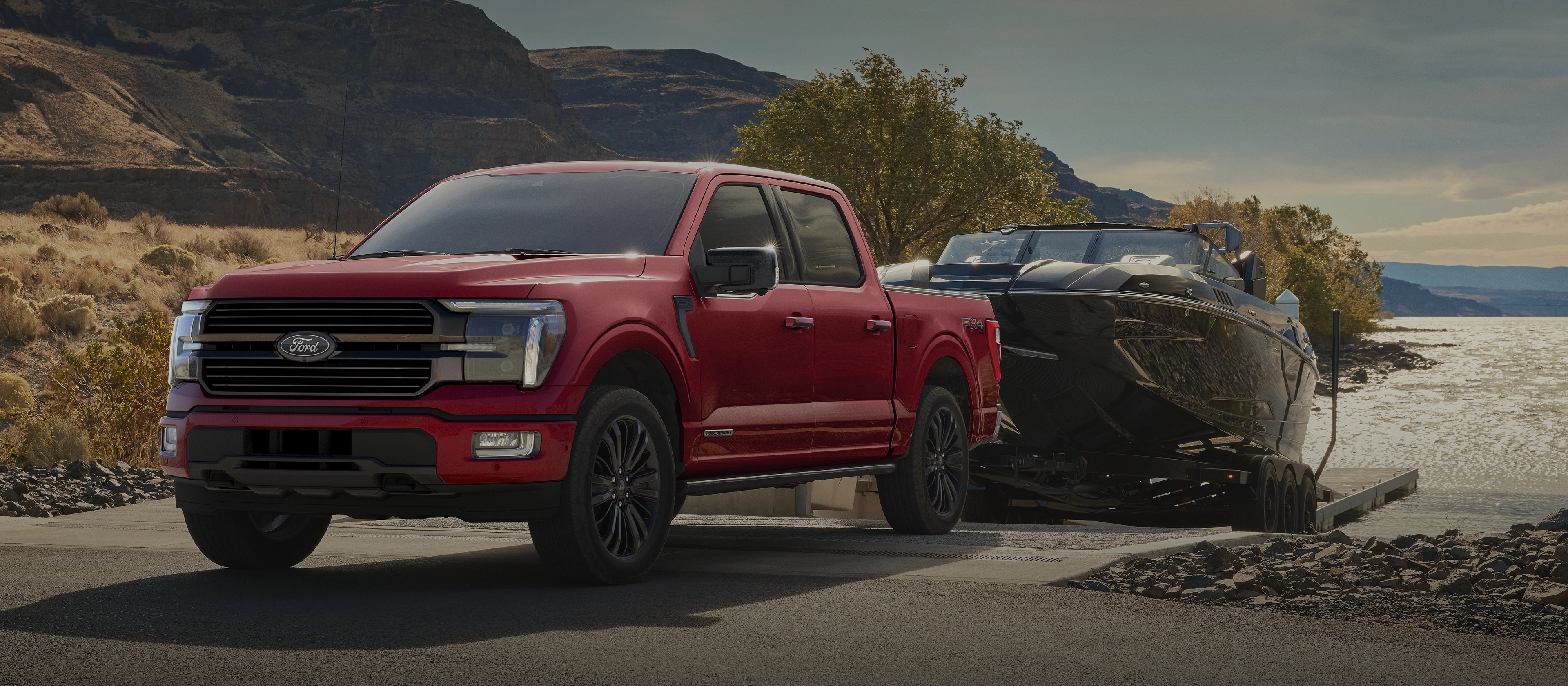 2025 Ford F-150® pickup backing a trailered boat into a lake slipway