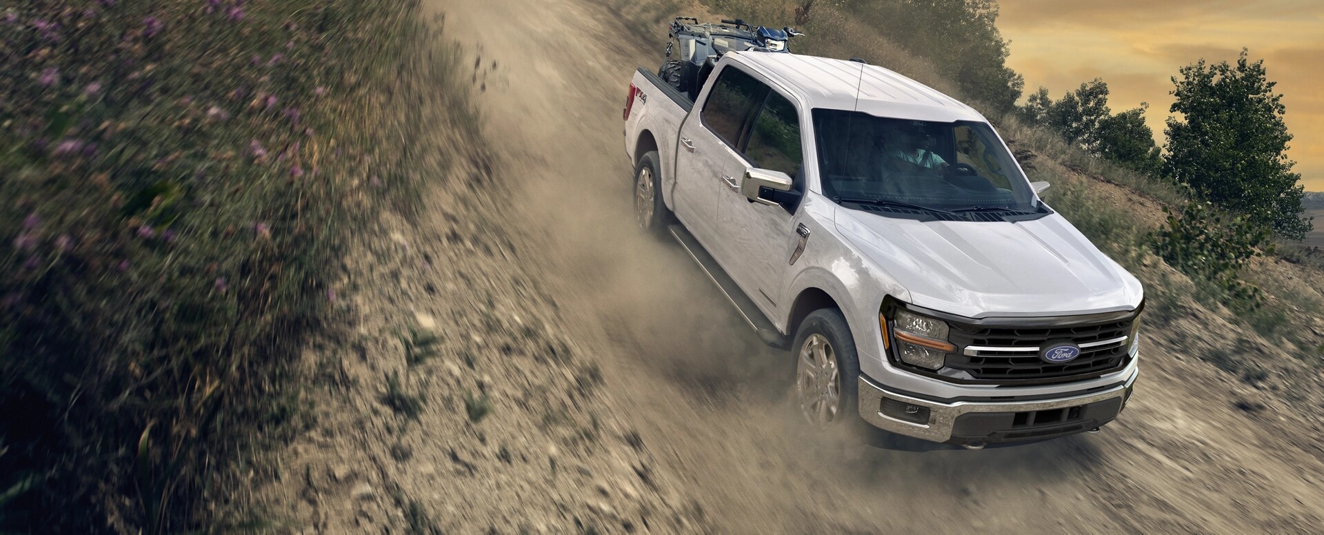 2025 Ford F150® PowerBoost® Hybrid pickup being driven on an open road