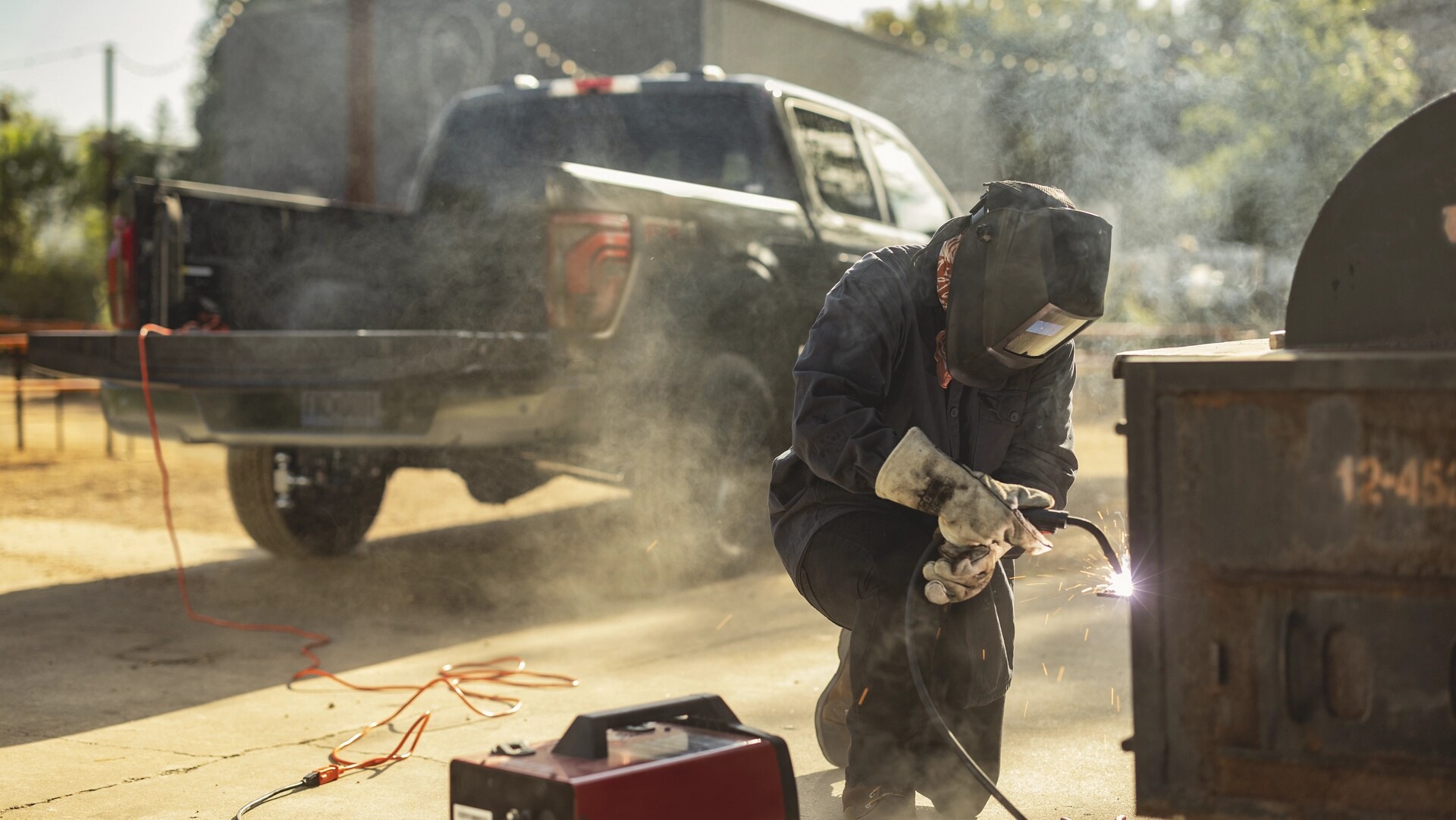 A welder using a welding machine plugged into the Pro Power Onboard™ feature