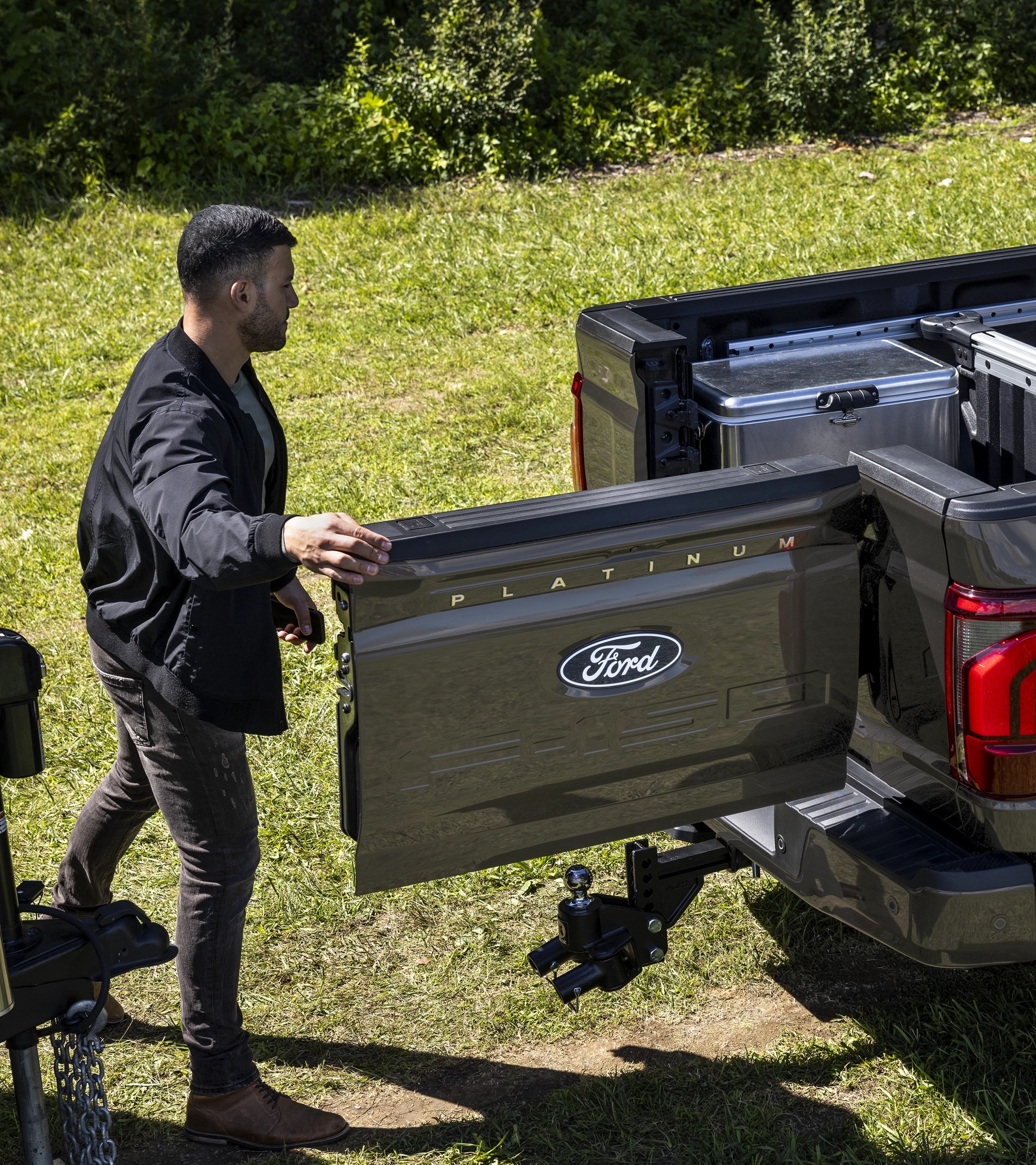 A man accesses the integrated swing gate of a 2025 Ford F-150® pickup with the Pro Access Tailgate