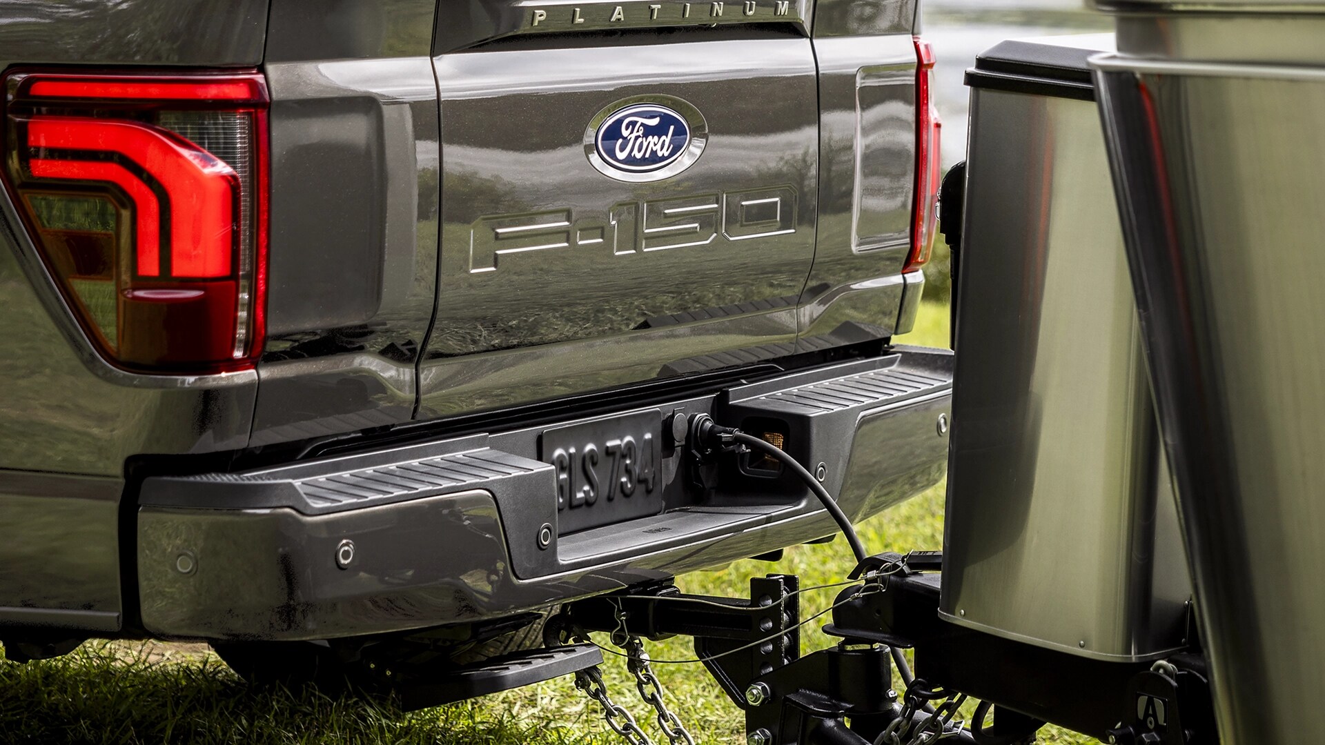 Close-up of a camper hitched to the trailer hitch on a 2025 Ford F-150® Platinum® pickup