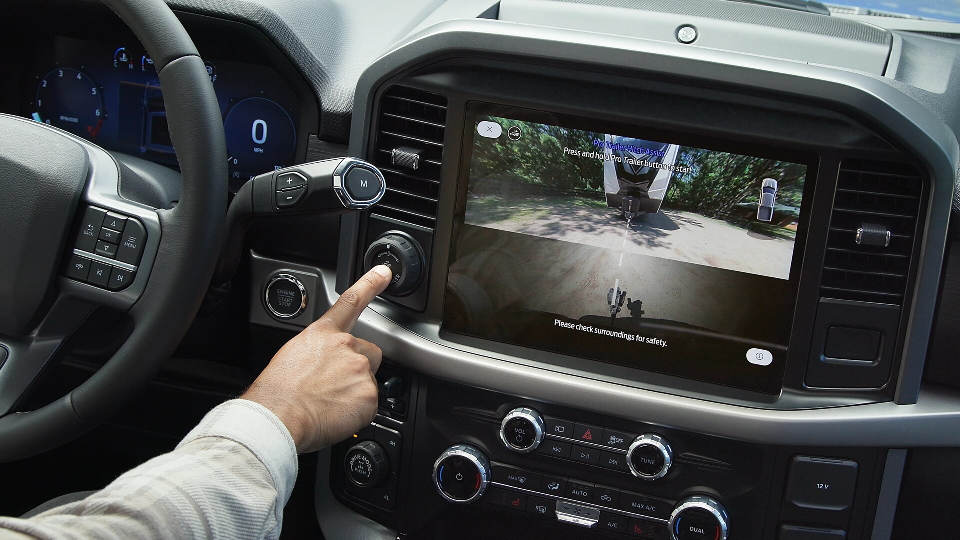 Person activates Pro Trailer Hitch Assist™ using the Pro Trailer knob inside a 2025 Ford F-150® truck