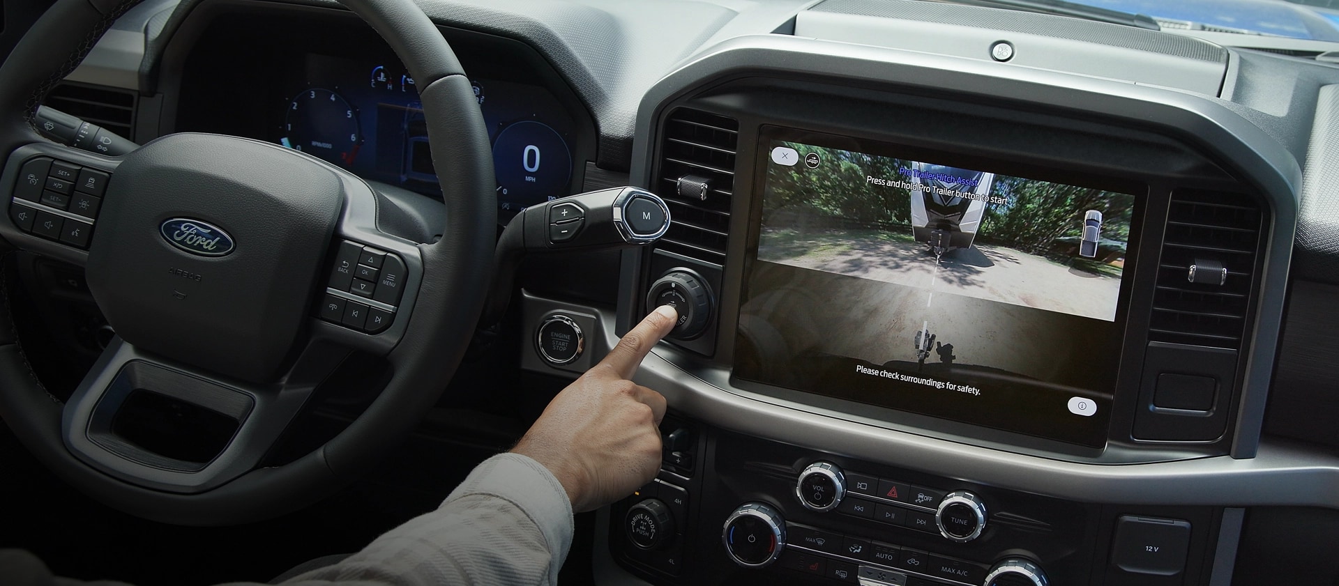 Person activates Pro Trailer Hitch Assist™ using the Pro Trailer knob inside a 2025 Ford F-150® truck