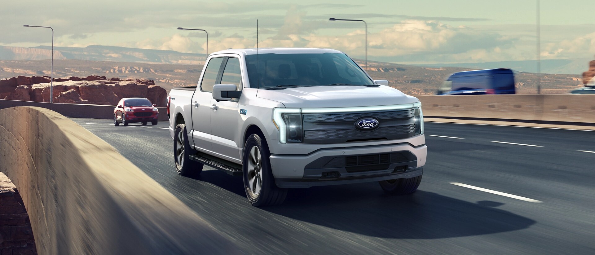 A 2025 Ford F-150® Lightning® pickup driving on an expressway