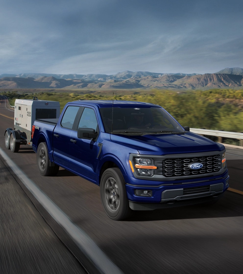 2025 Ford F-150® truck towing a trailer along a desert highway
