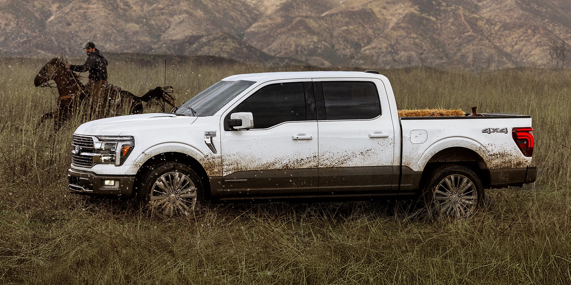 A person horseback riding next to a dirty 2025 Ford F-150® truck.