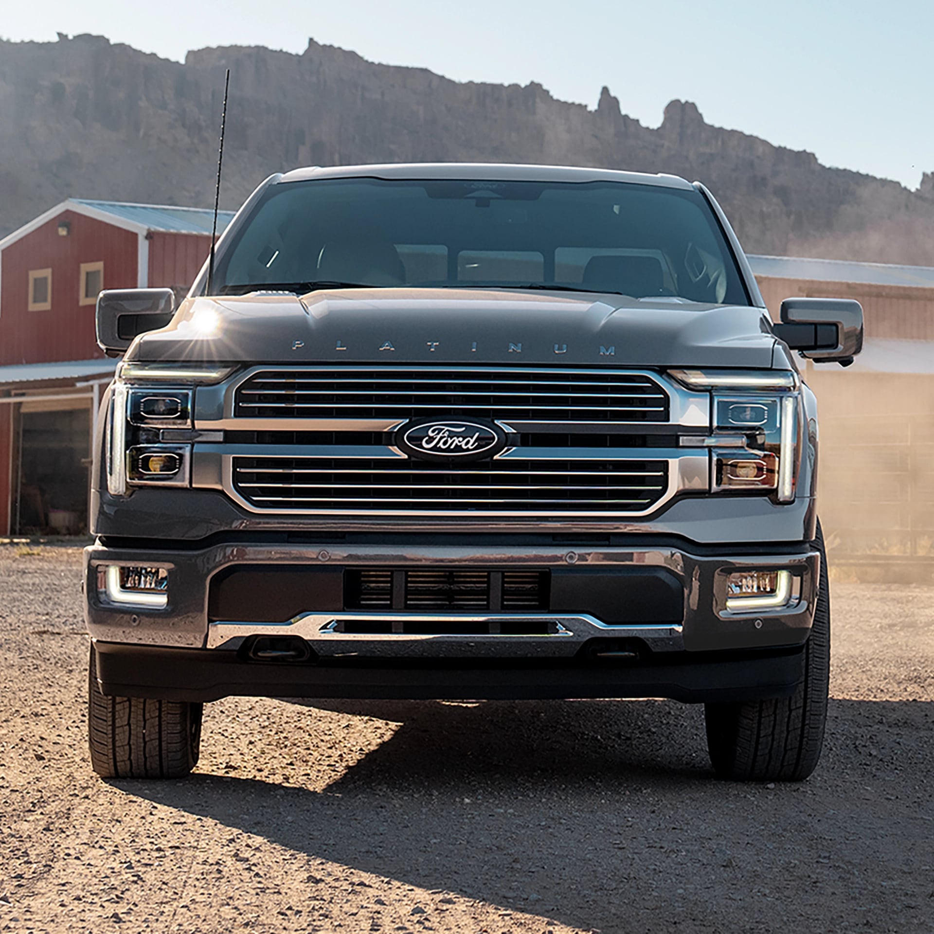 2025 Ford F-150® parked in front a barn and farm equipment.