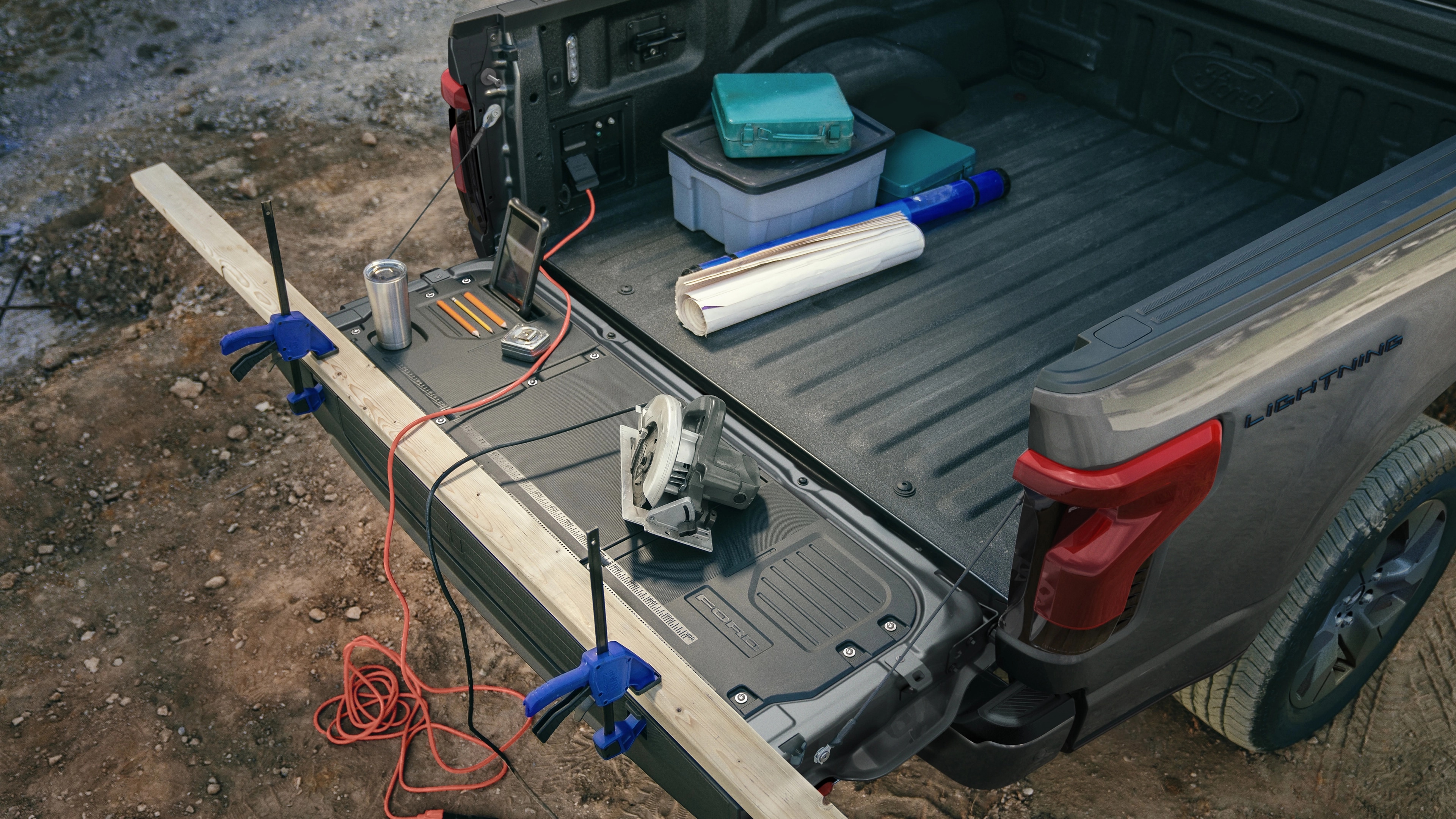 The cargo bed of a 2025 Ford F-150® Lightning® pickup with the tailgate down, showing the Tailgate Work Surface