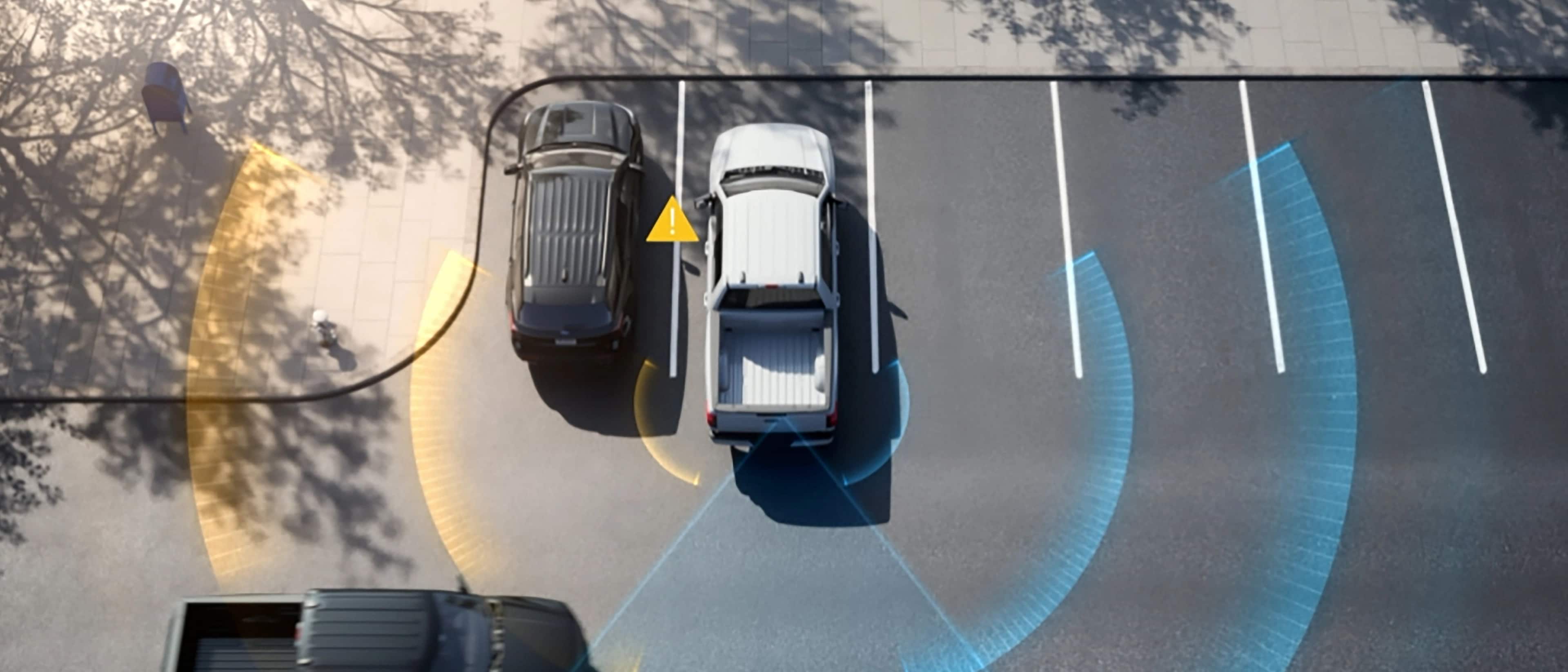 An aerial view demonstrating the Cross Traffic Alert feature with a 2025 Ford F-150® Lightning® parked at a parking lot