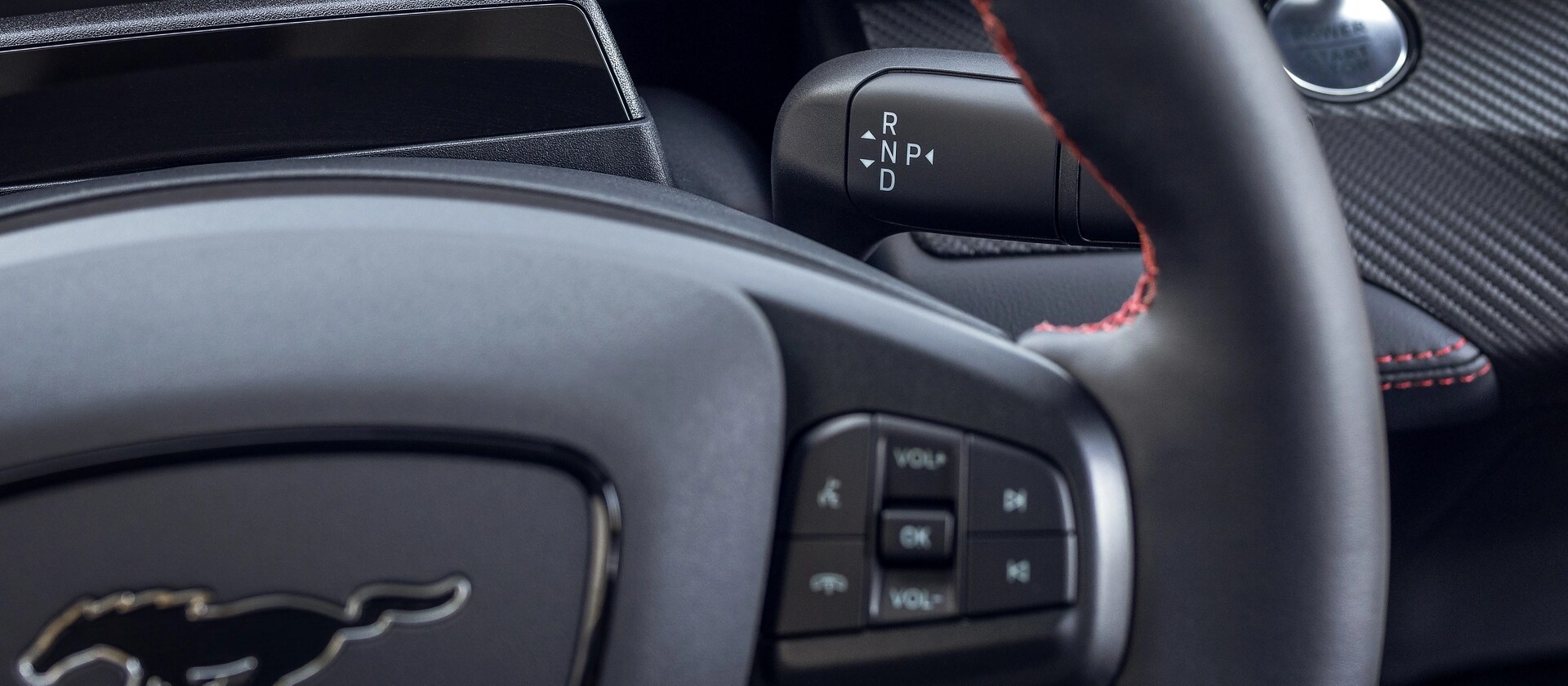 2025 Ford Mustang Mach-E® close-up of steering wheel showing audio controls