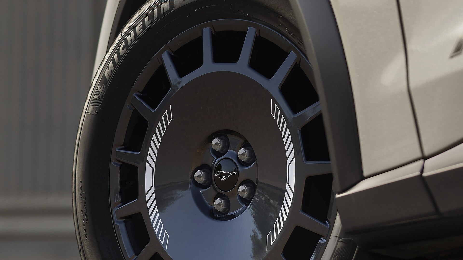 19" Dark Carbonized Grey wheels with Michelin® CrossClimate®2 performance tires on the 2025 Ford Mustang Mach-E® Rally model