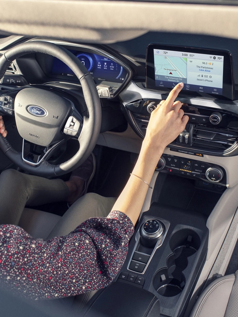 A woman driving a Ford vehicle.