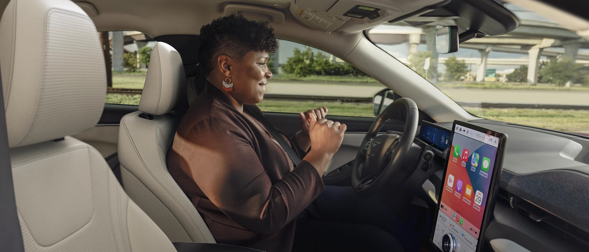 Woman using Ford Bluecruise hands-free highway driving in a 2025 Ford Mustang Mach-E®