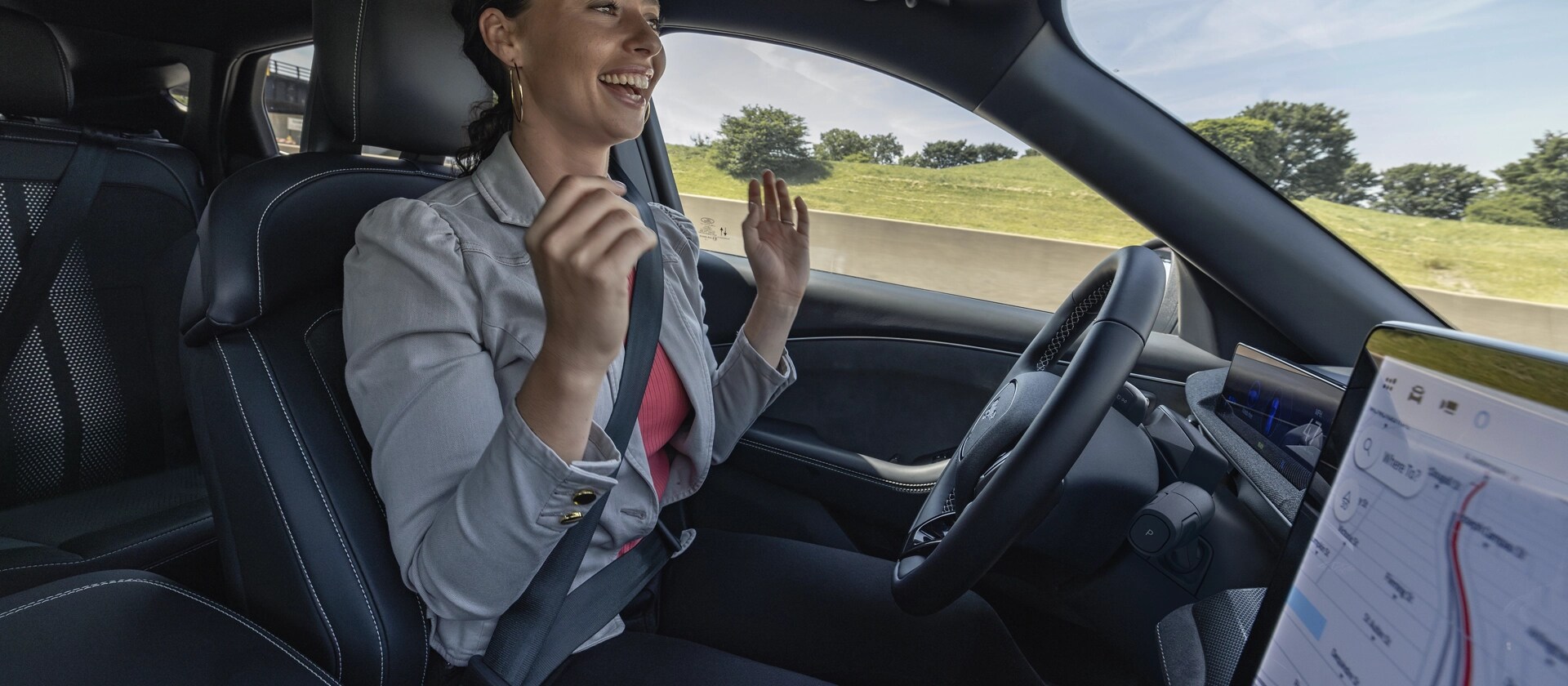 Woman using Ford BlueCruise hands-free highway driving in a 2025 Ford Mustang Mach-E®