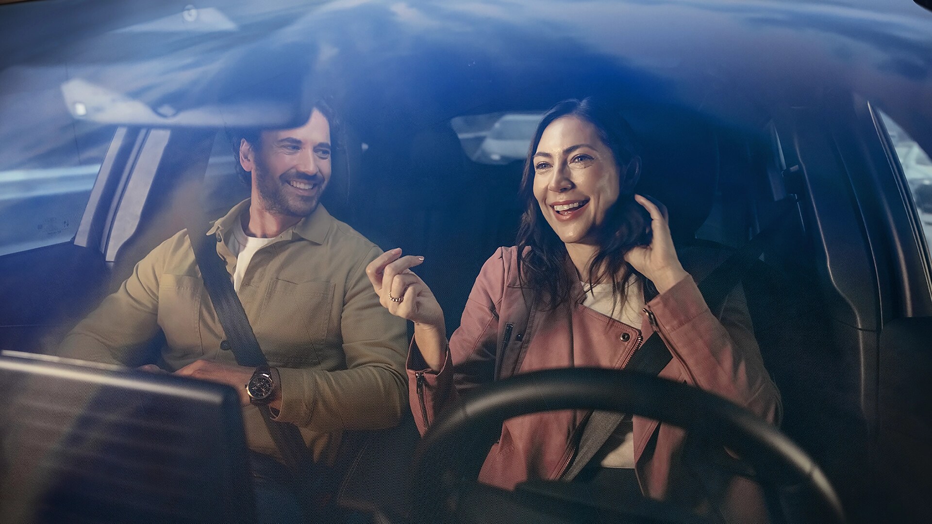 Two people inside a 2025 Ford Mustang Mach-E® seen through the windshield 
