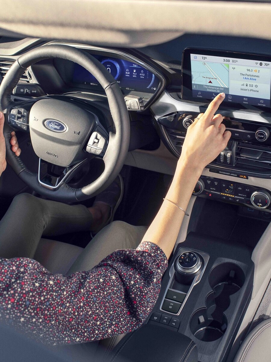 A woman driving a Ford vehicle