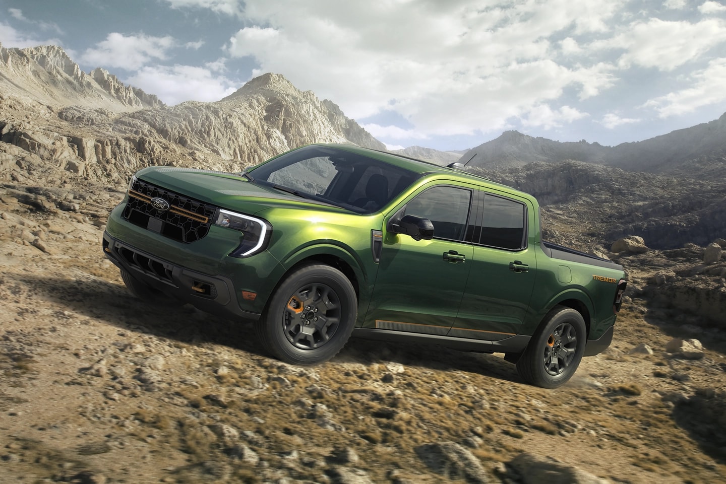 A 2025 Ford Maverick® Tremor® pickup driving up a rocky hillside