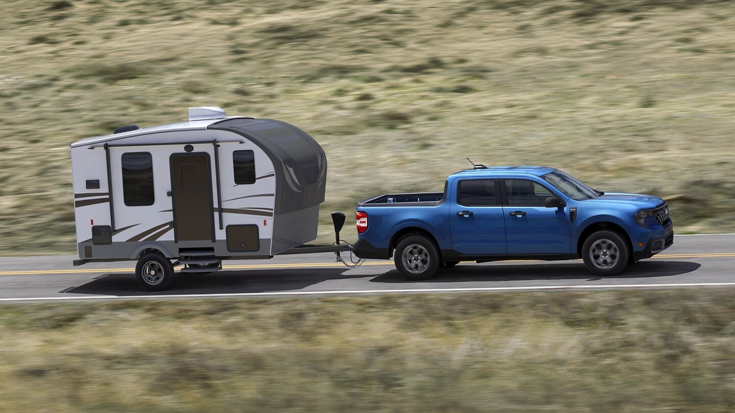 A 2025 Ford Maverick® pickup towing a travel trailer