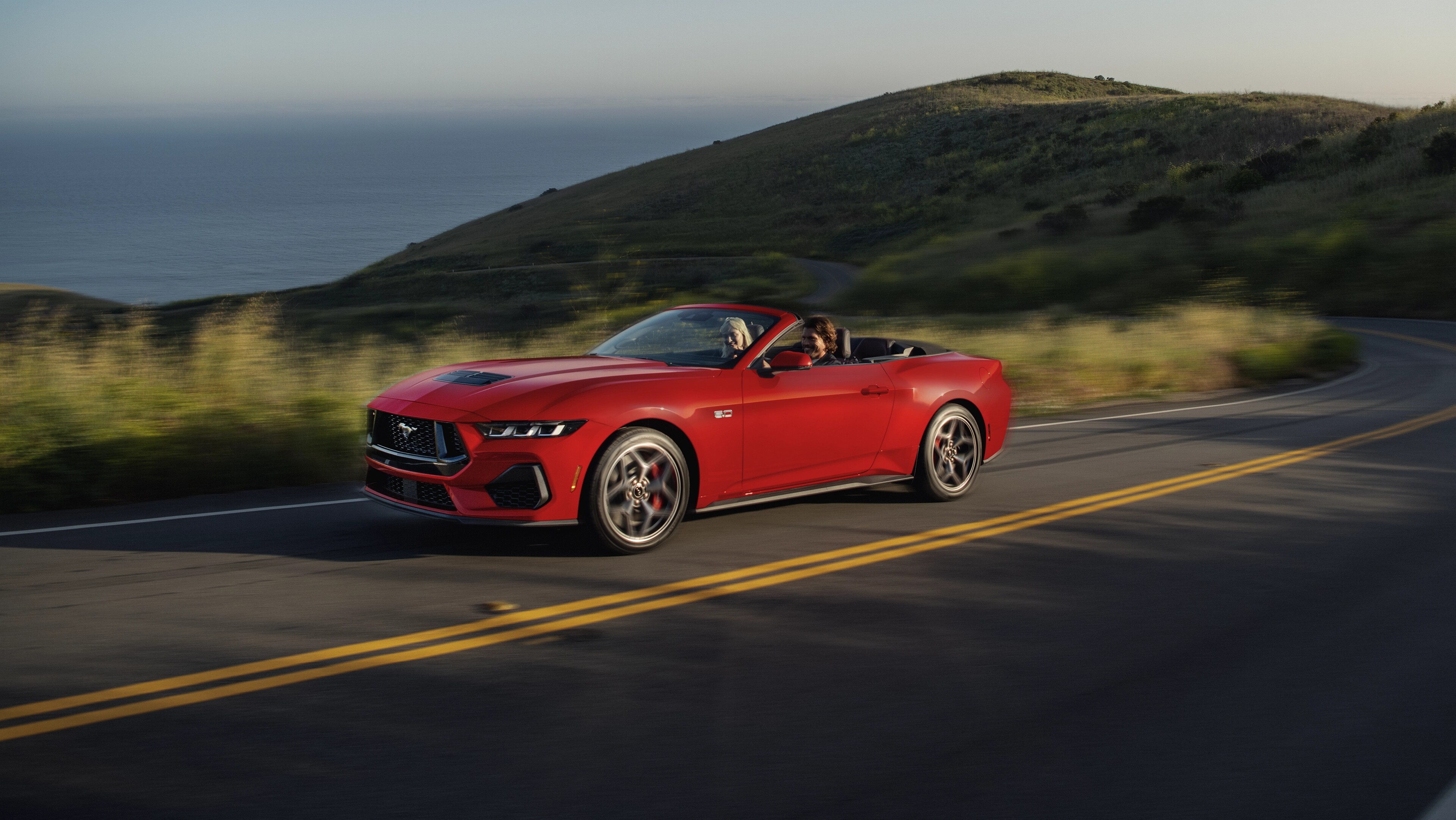 2025 Ford Mustang® GT convertible being driven on a hill