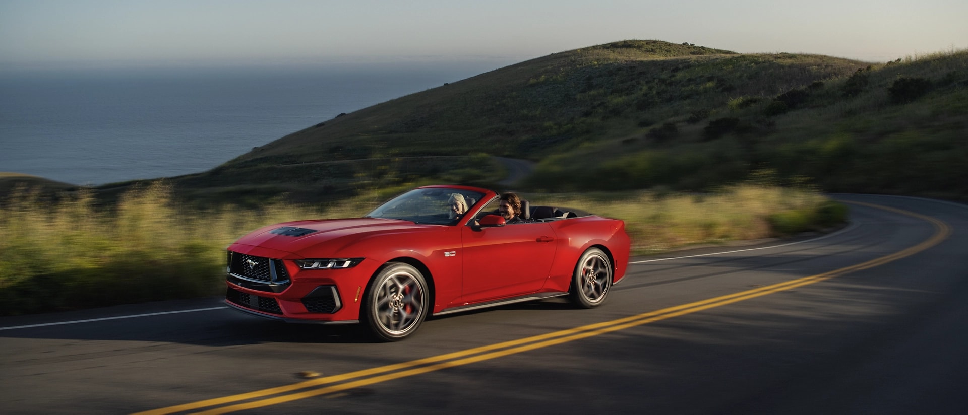 2025 Ford Mustang® GT convertible being driven on a hill