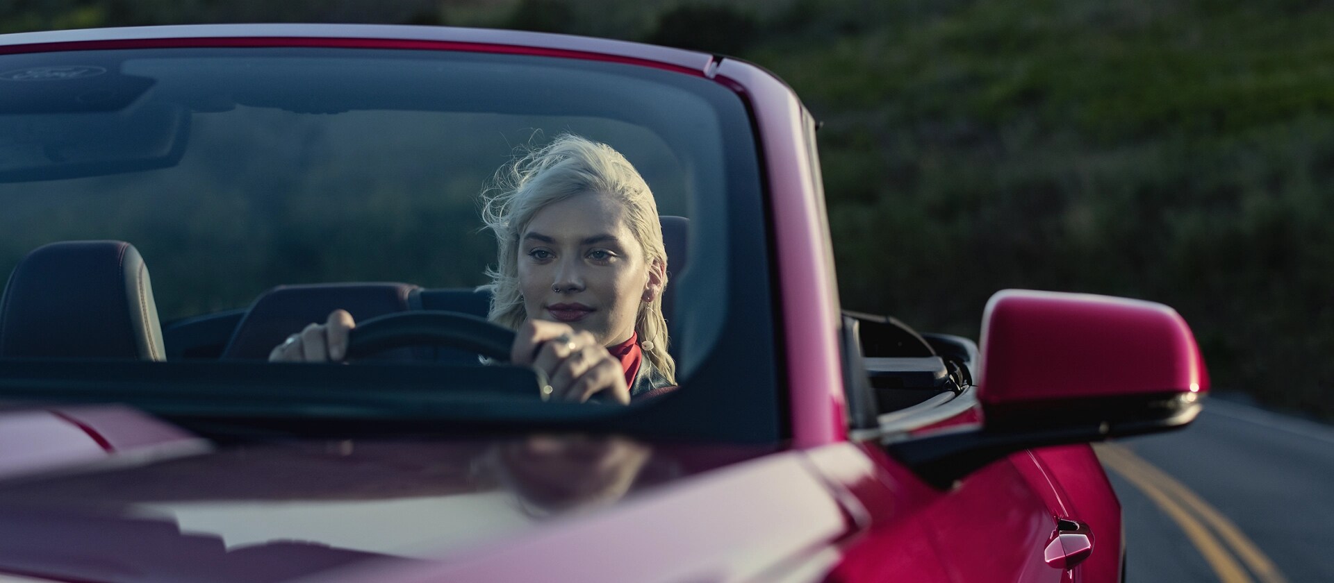 Person driving a 2025 Ford Mustang® GT Convertible on a highway