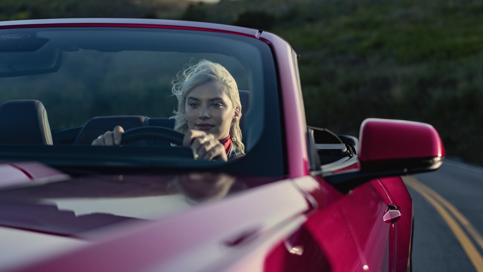 Person driving a 2025 Ford Mustang® GT Premium Convertible on a highway