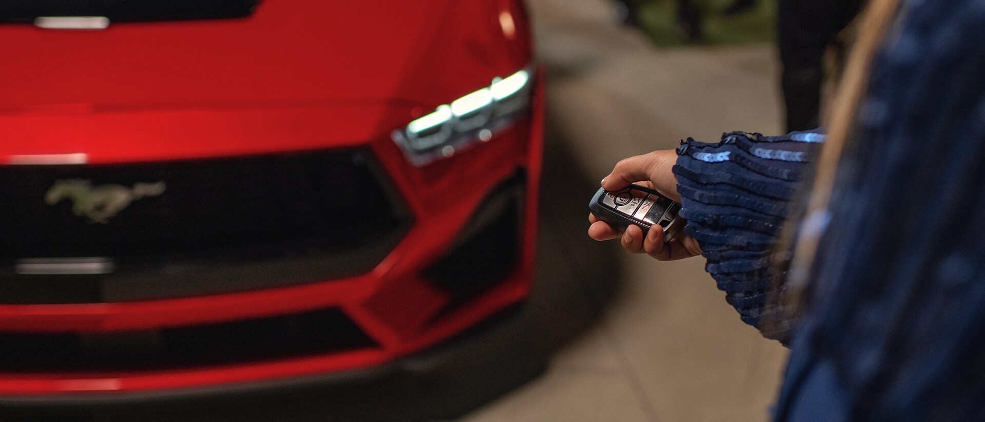 Person using the remote rev feature on a 2025 Ford Mustang® coupe with available automatic transmission
