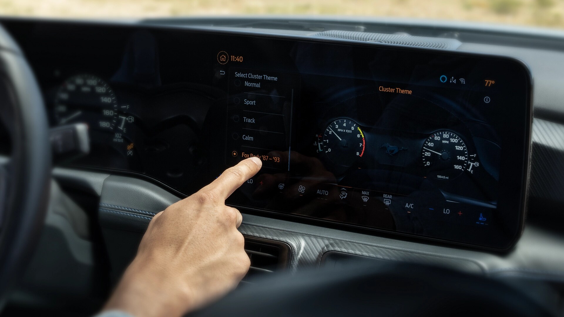 Person using the touchscreen in a 2025 Ford Mustang® model