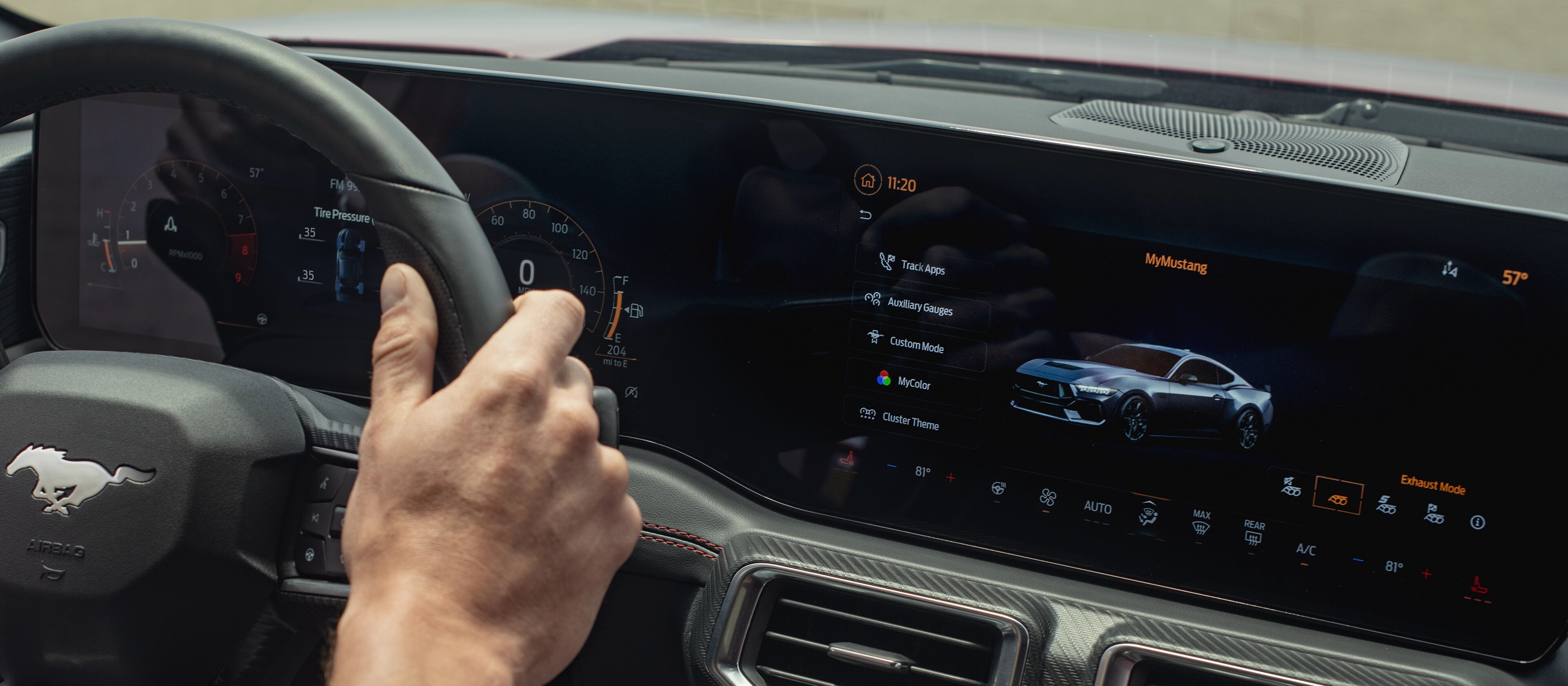 Person driving a 2025 Ford Mustang® model with the available 13.2" centre touchscreen