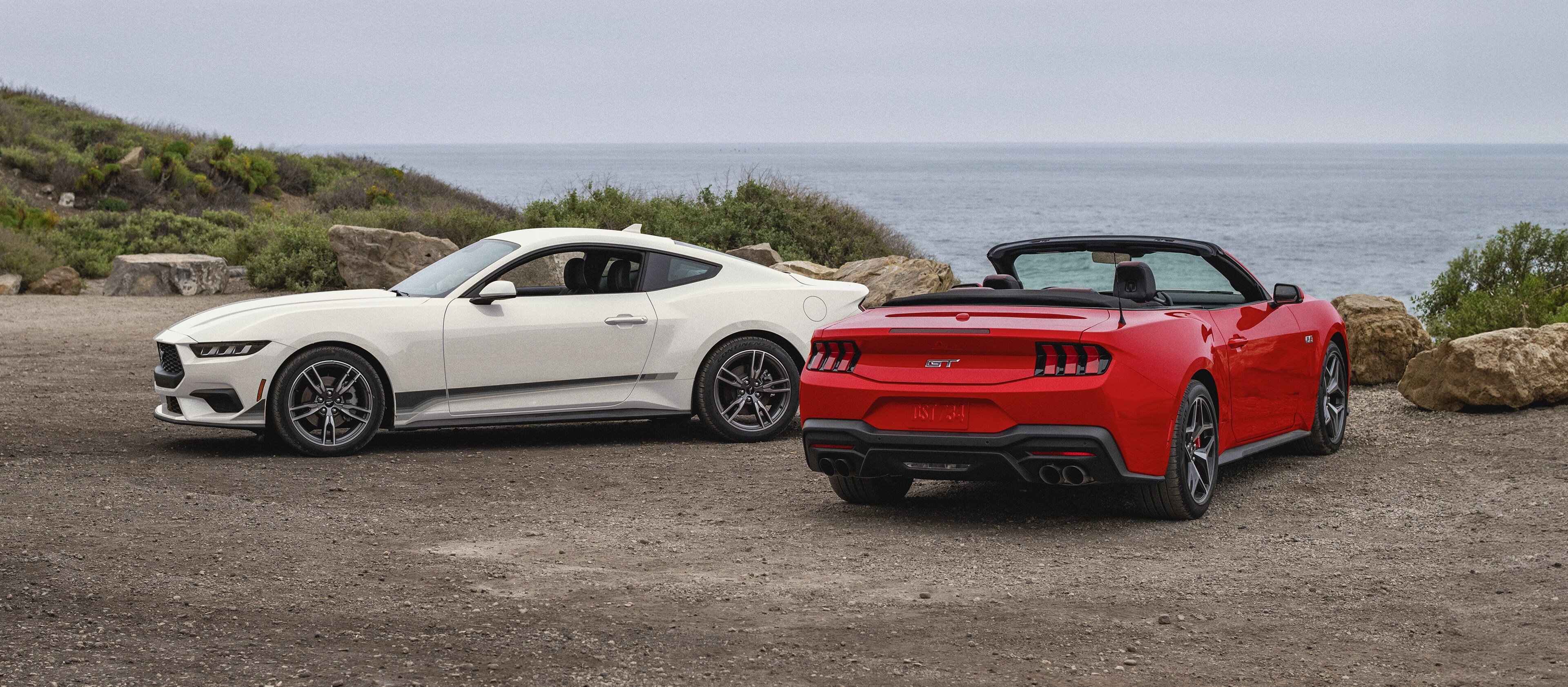 2025 Ford Mustang® coupe and convertible parked near the ocean