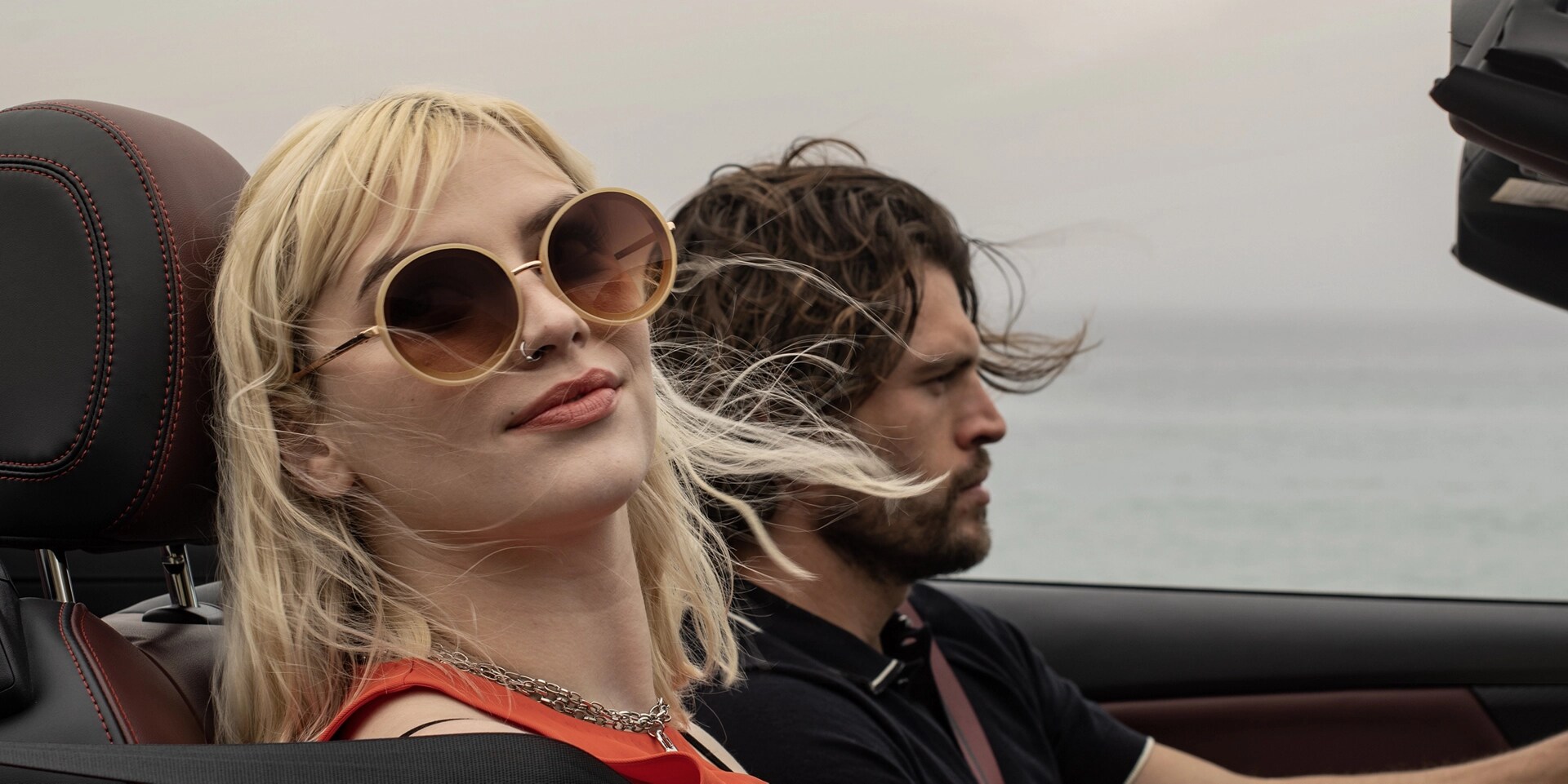 2026 Ford Mustang® GT Premium Convertible with a man and woman driving along the oceanside