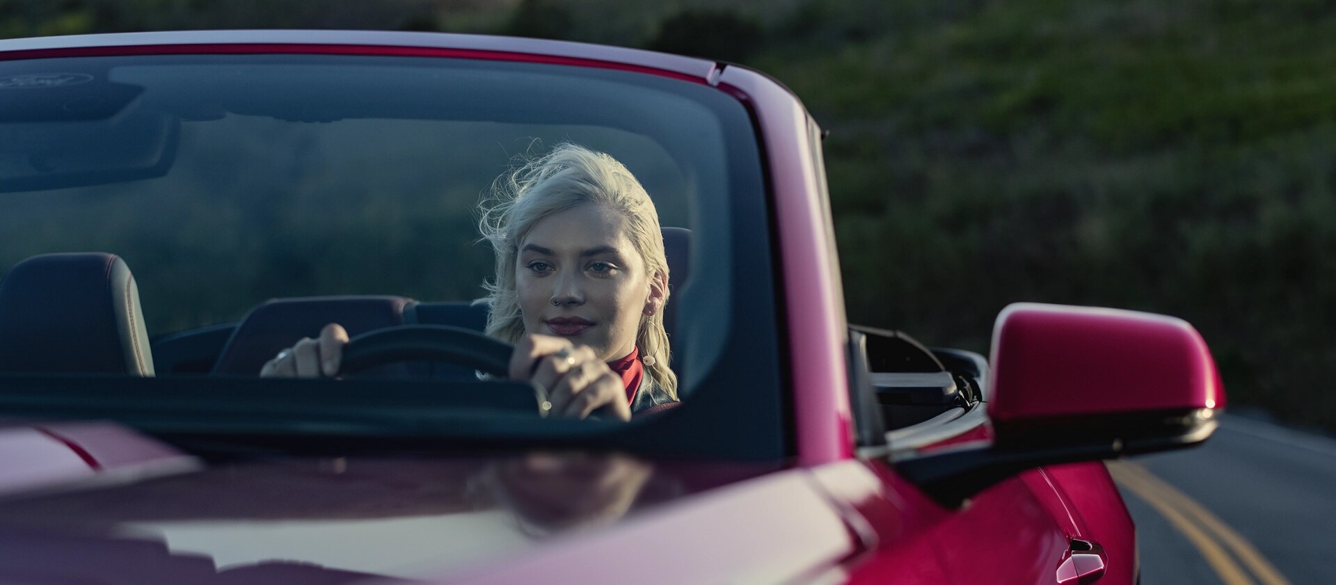 Person driving a 2026 Ford Mustang® GT convertible on a highway