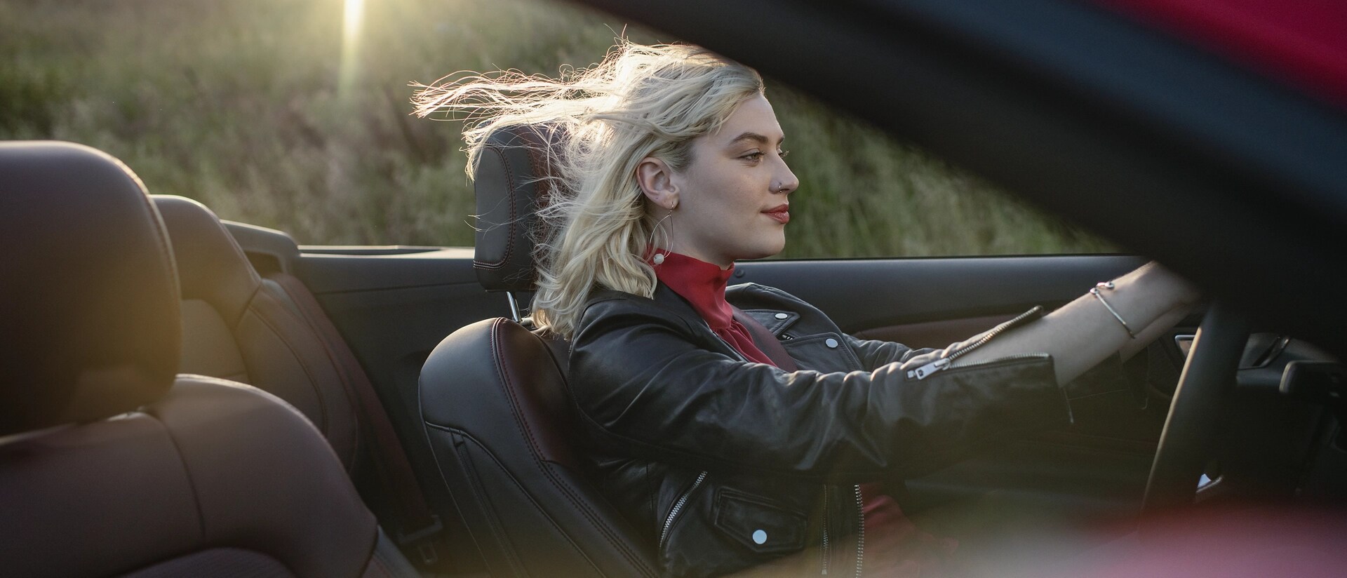 Person driving a 2026 Ford Mustang® GT convertible on a highway