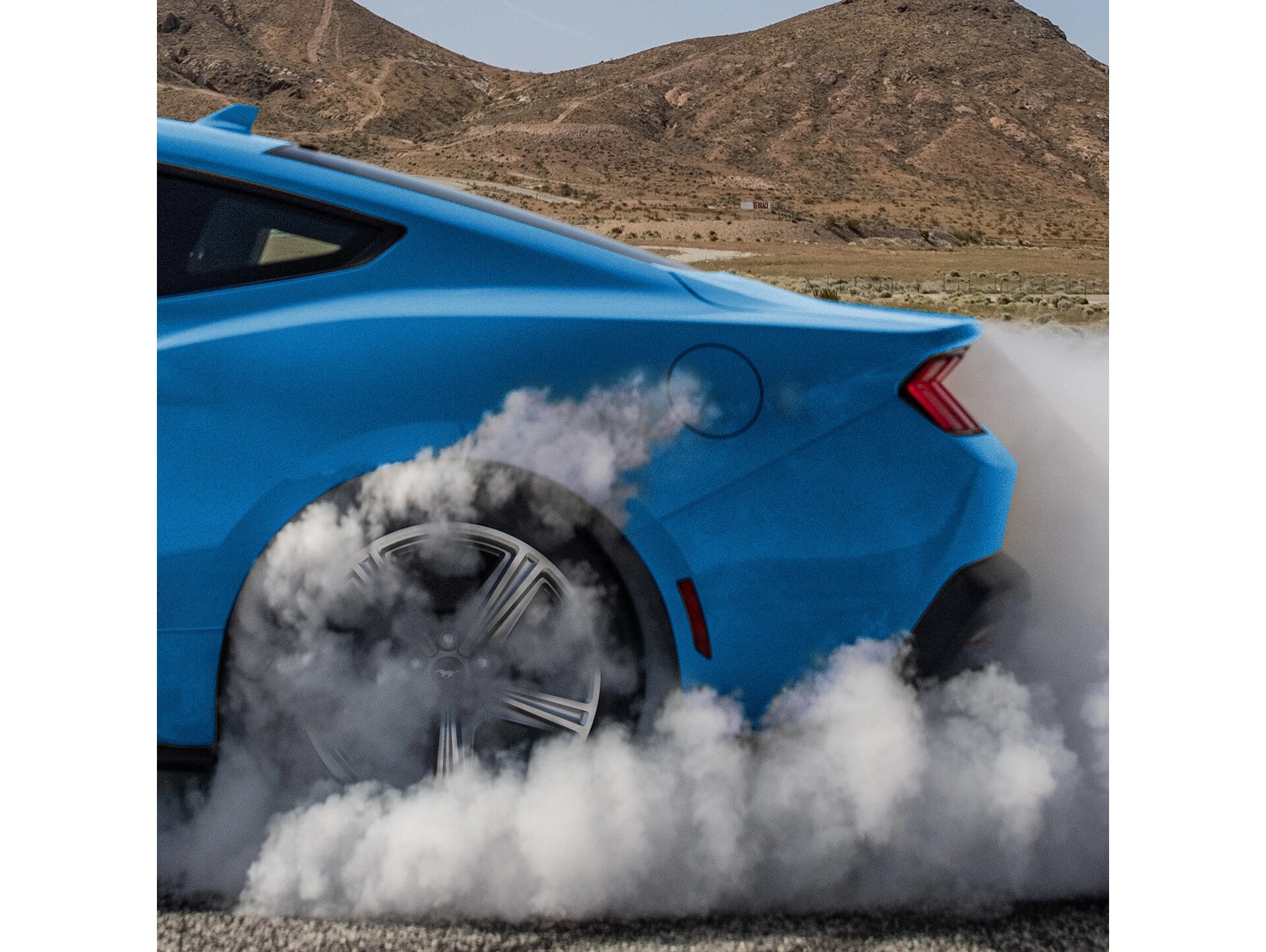 2026 Ford Mustang® EcoBoost® in Grabber Blue spinning around with smoke coming out of back tire