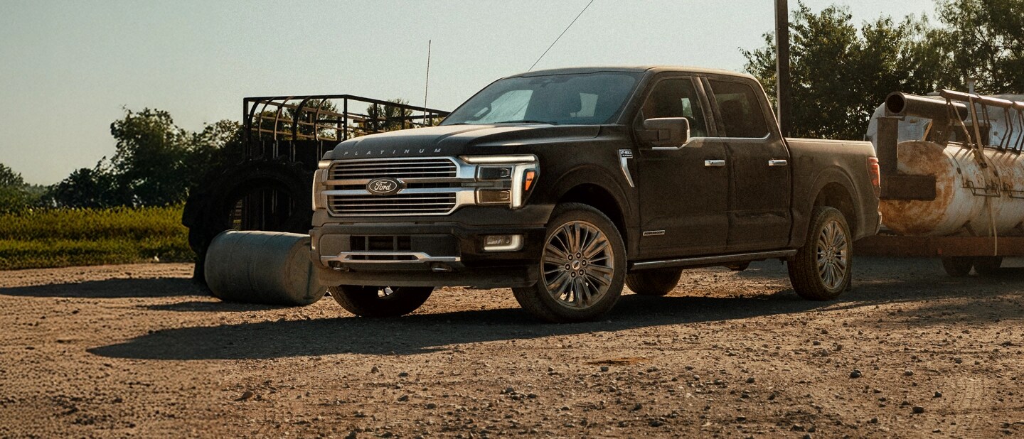 An F-150 towing heavy equipment.