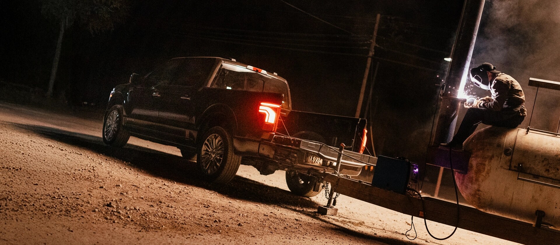 A man uses the Pro Power Onboard feature to power a welding tool plugged into an F-150.