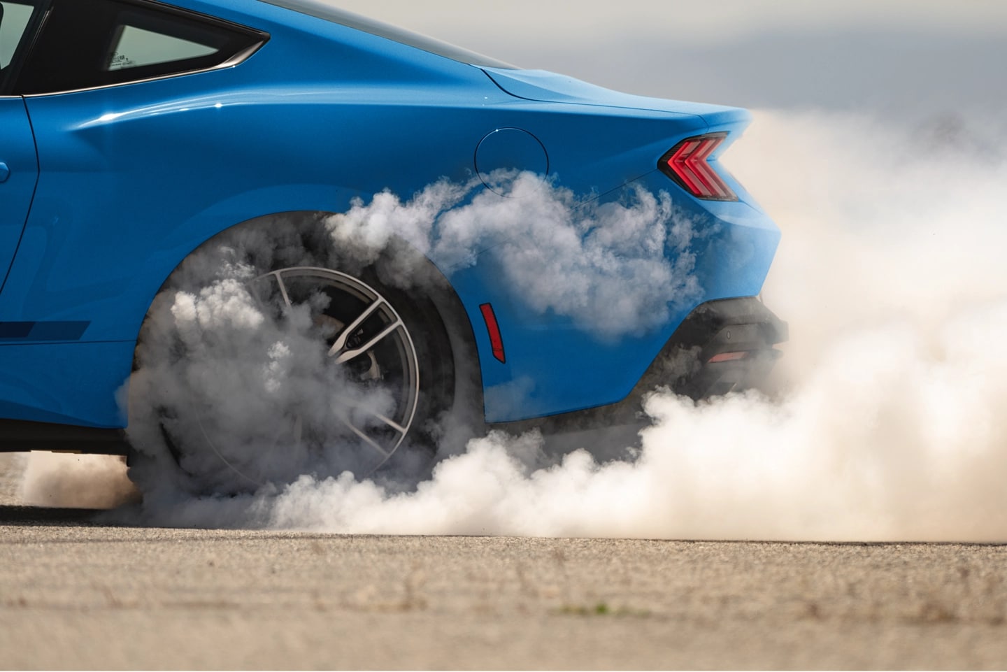 Mustang with smoking tires.