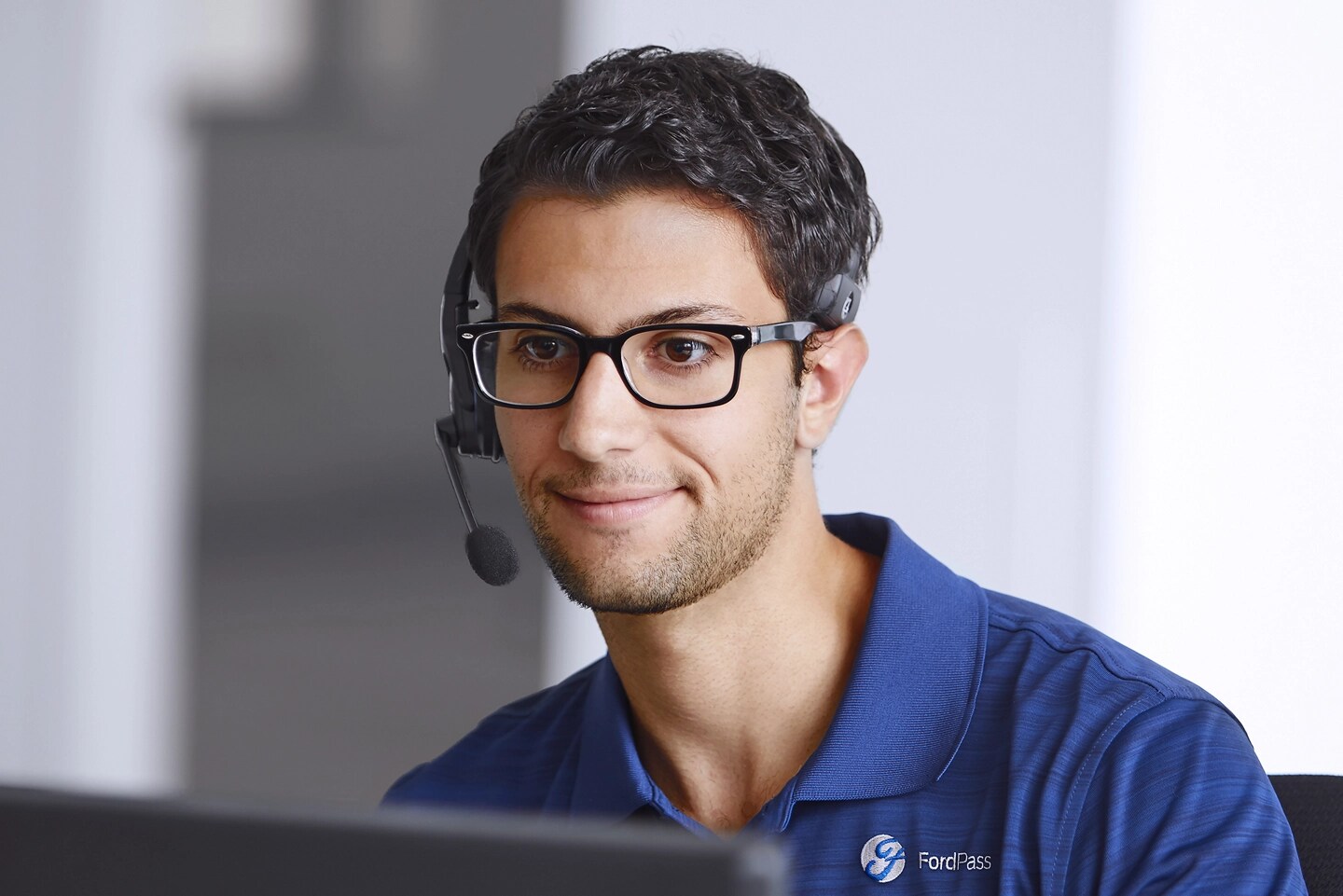 A call centre agent looks at a computer monitor.
