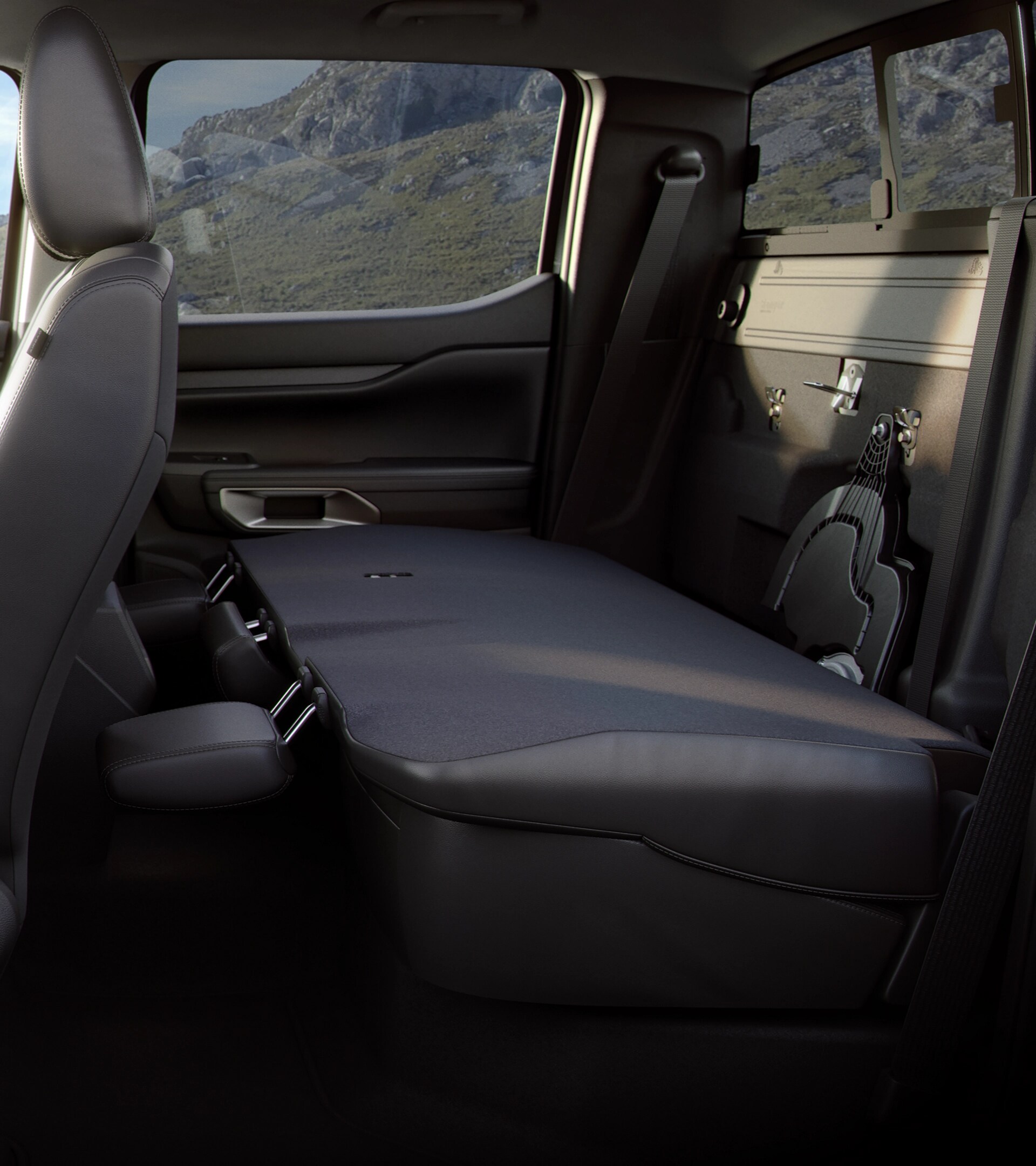 Interior shot showcasing the rear seat folded down in a 2025 Ford Ranger®