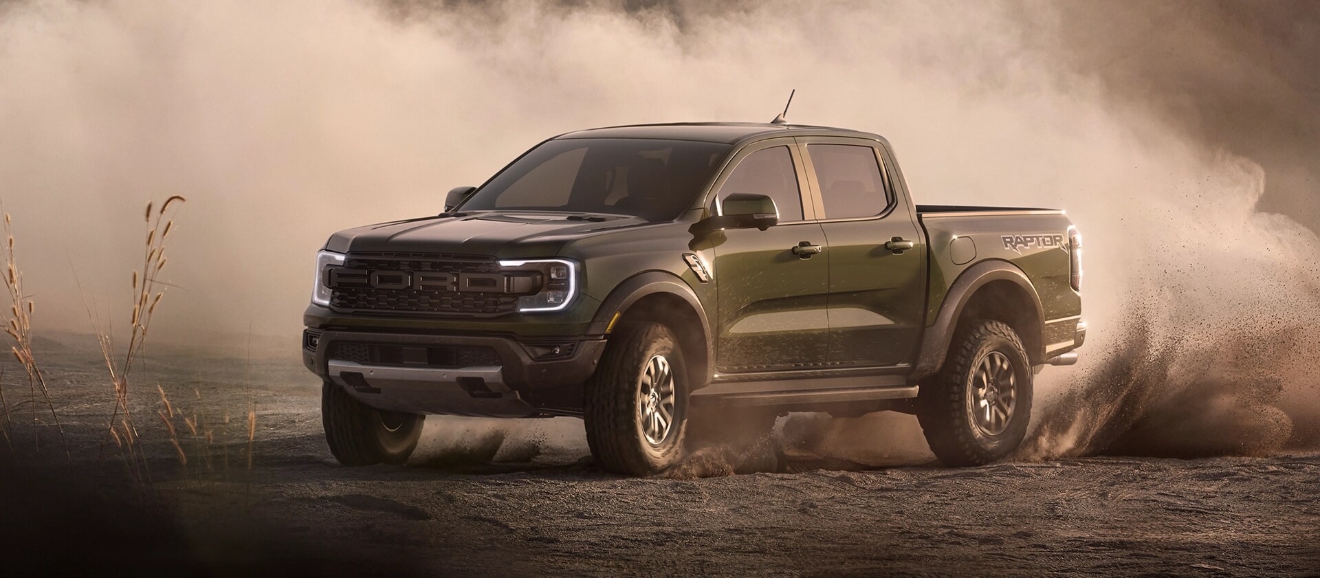 A 2025 Ford Ranger® Raptor® pickup is being driven off kicking up dust