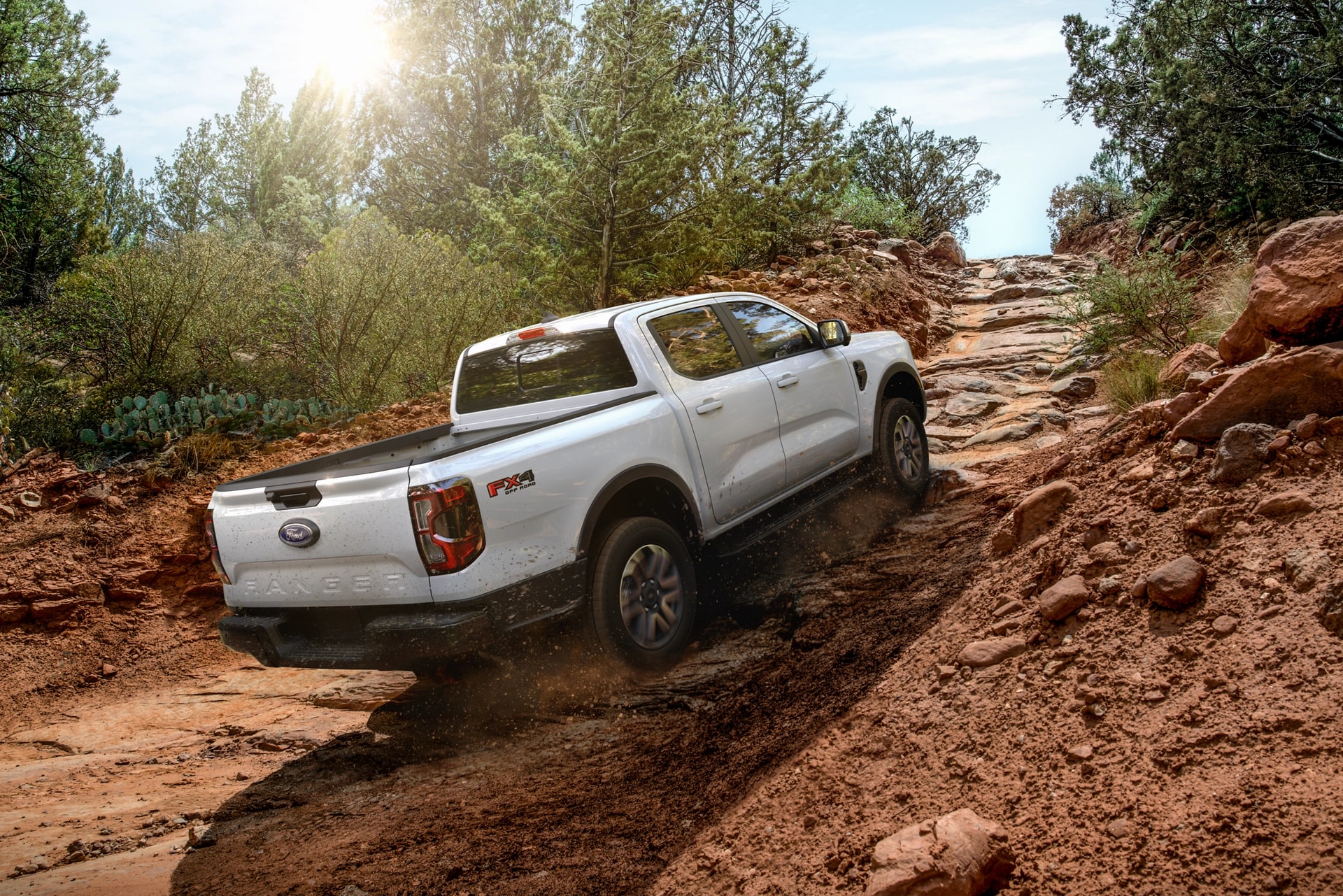 A white 2025 Ford Ranger® being driven up a steep rocky trail