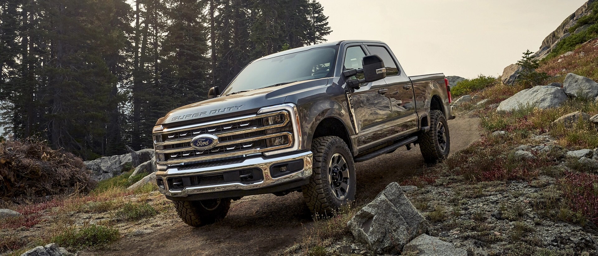 2026 Ford Super Duty® F-250® with the Tremor® Off-Road Package parked on a rocky, mountainous dirt road