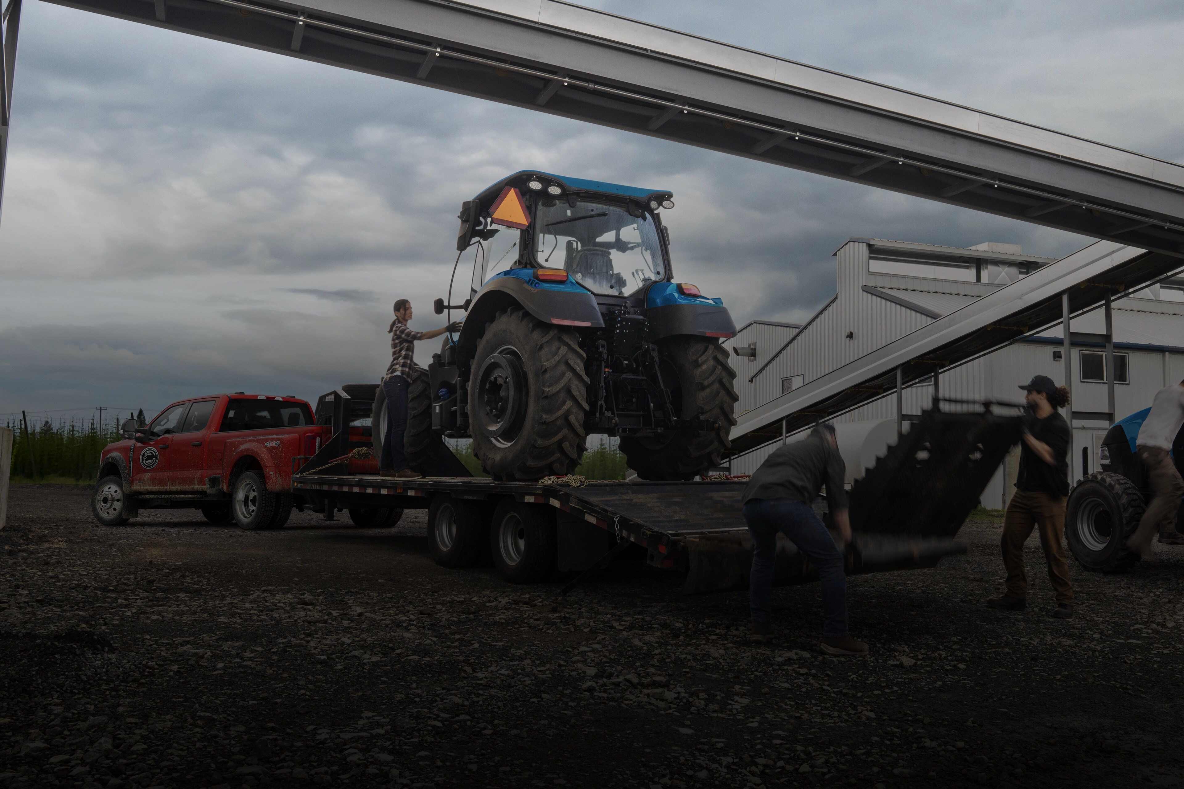 2026 Ford Super Duty® F-450® XL pulling a trailer carrying a large tractor