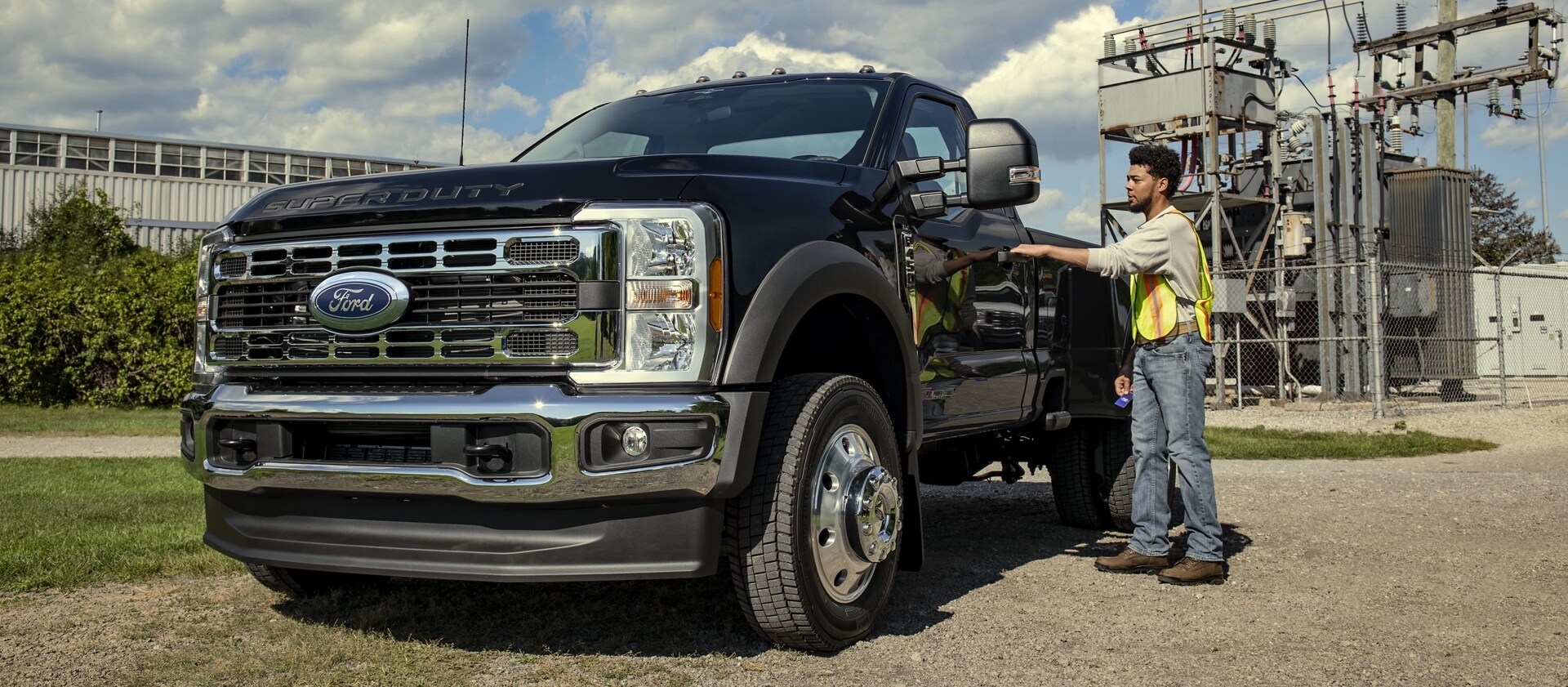 A person opening the driver door of their 2026 Ford Super Duty® F-450® XL model with the Chrome Appearance Package